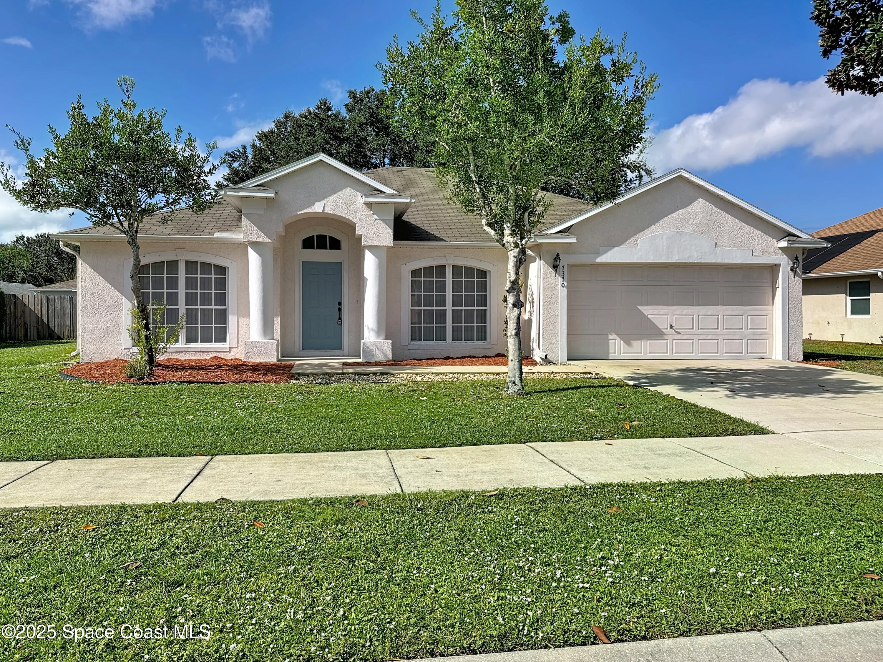 7370 Joshua Place Cocoa, FL 32927 - Photo 1 of 21 a front view of a house with a yard