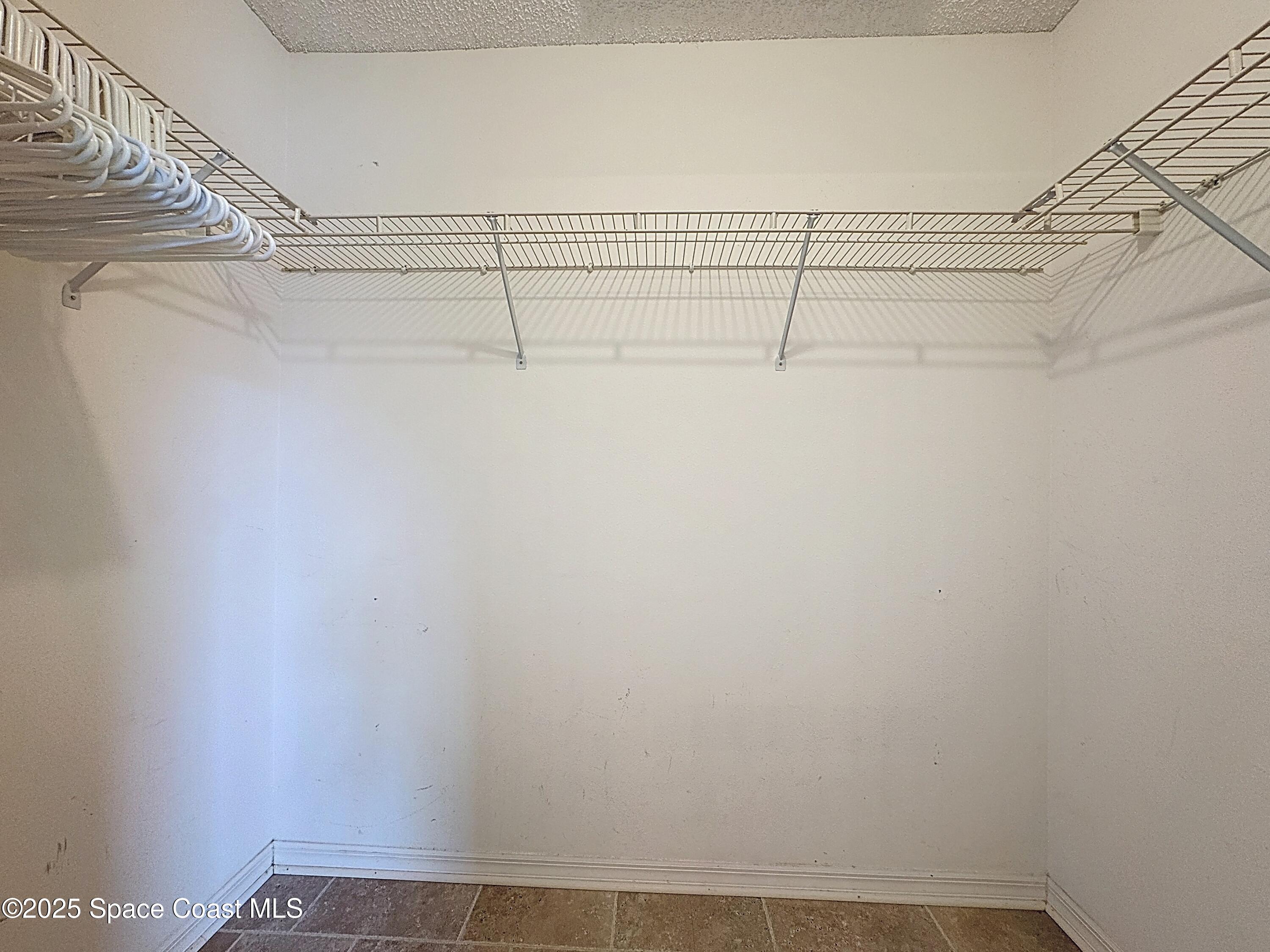 7370 Joshua Place Cocoa, FL 32927 - Photo 11 of 21 a view of a room with racks on the wall