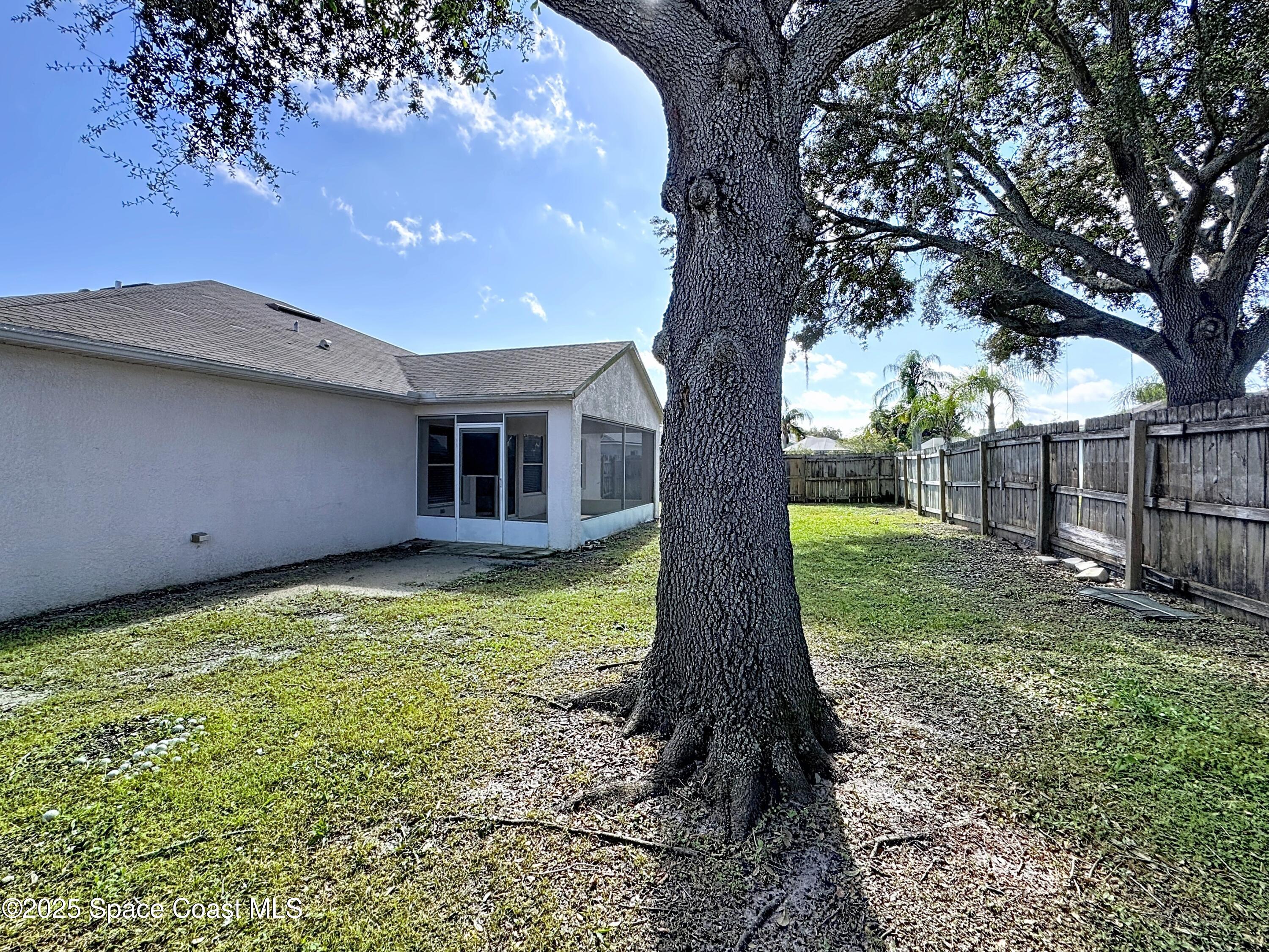 7370 Joshua Place Cocoa, FL 32927 - Photo 18 of 21 a backyard of a house with lots of green space