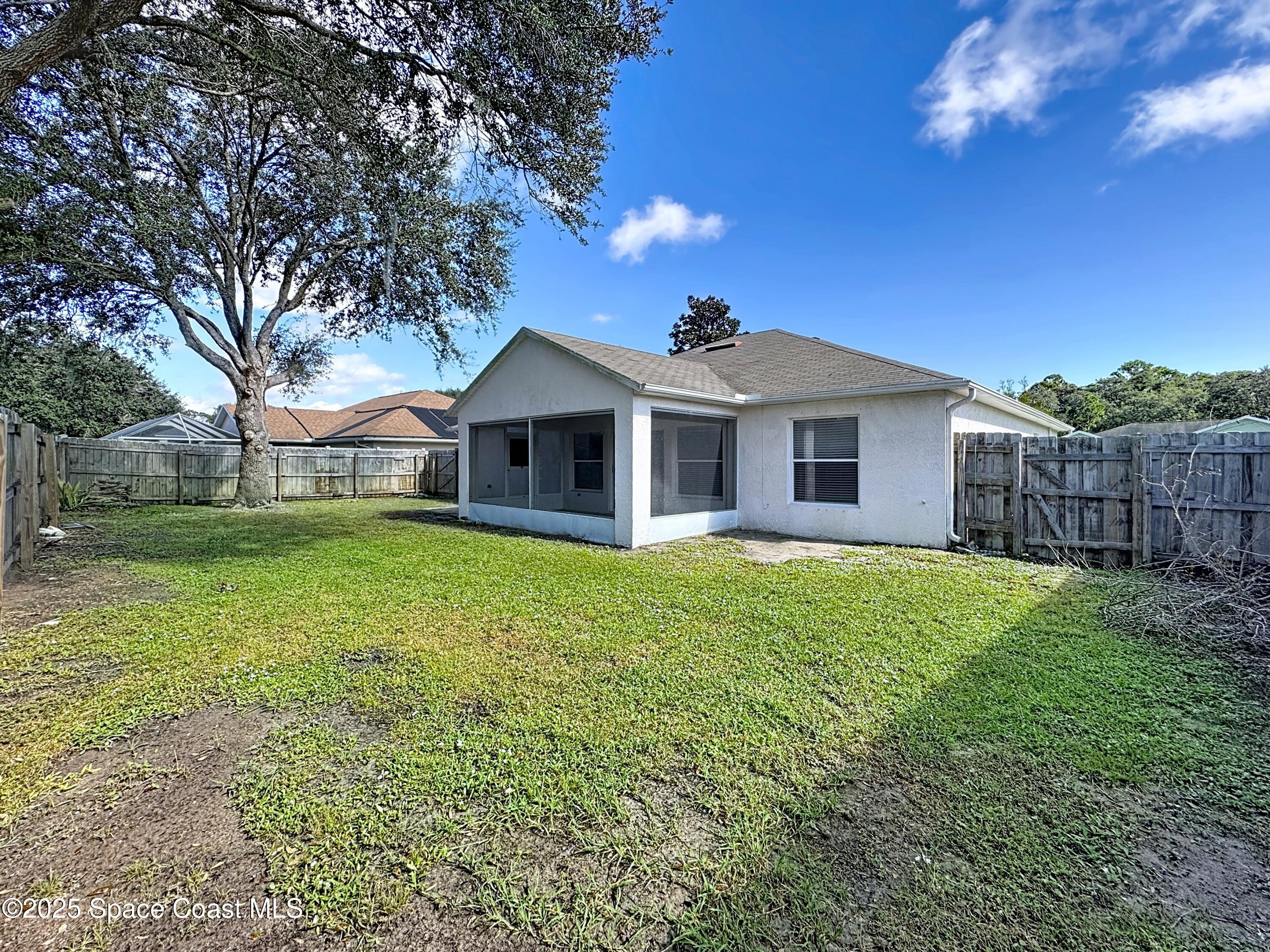 7370 Joshua Place Cocoa, FL 32927 - Photo 19 of 21 a front view of a house with yard and green space