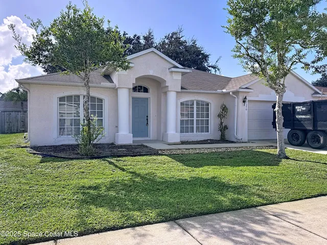 a front view of a house with a yard