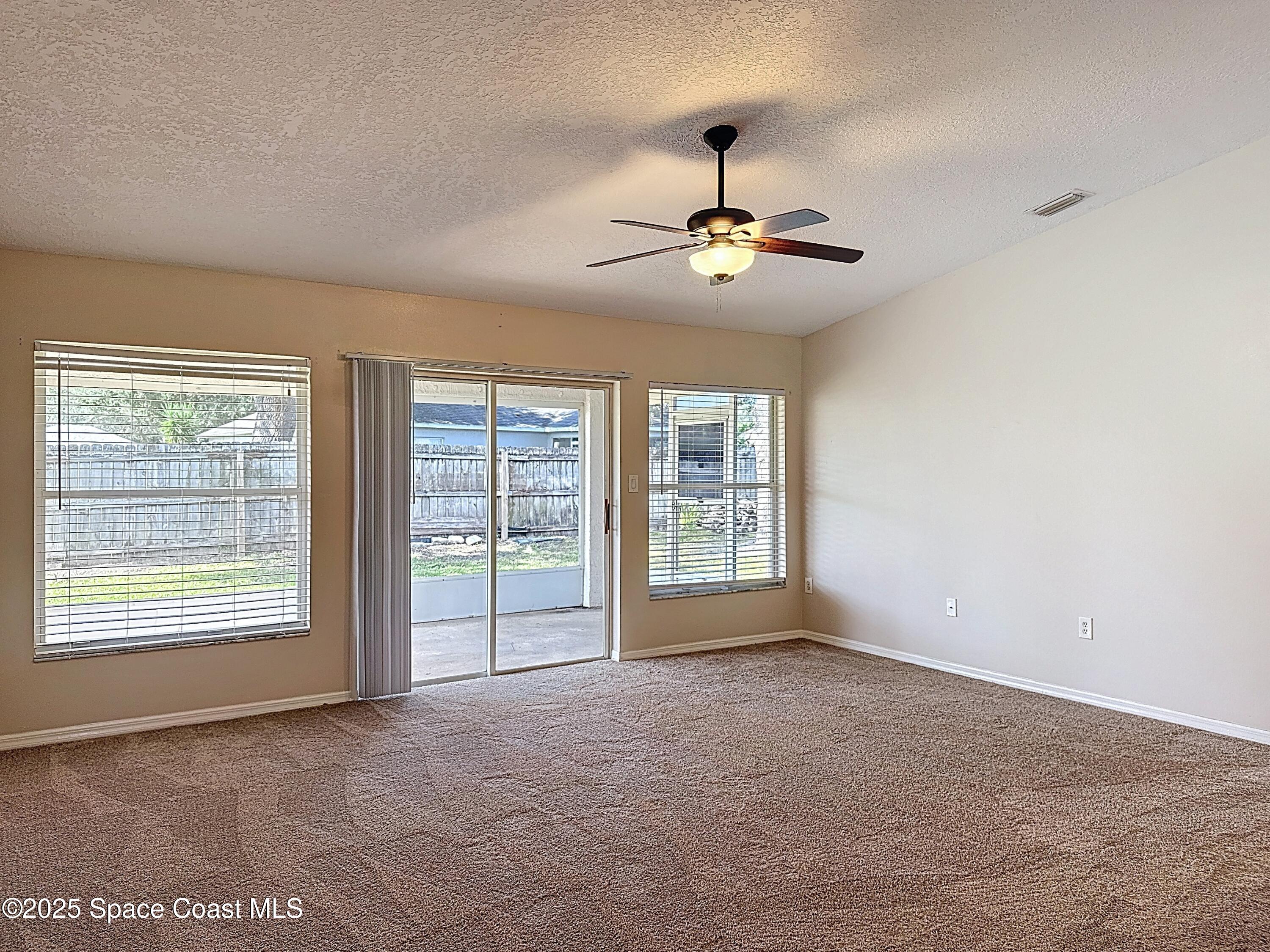 7370 Joshua Place Cocoa, FL 32927 - Photo 5 of 21 a view of an empty room with a window