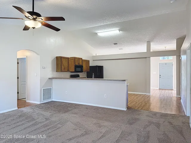 a view of a kitchen with a dishwasher and a refrigerator