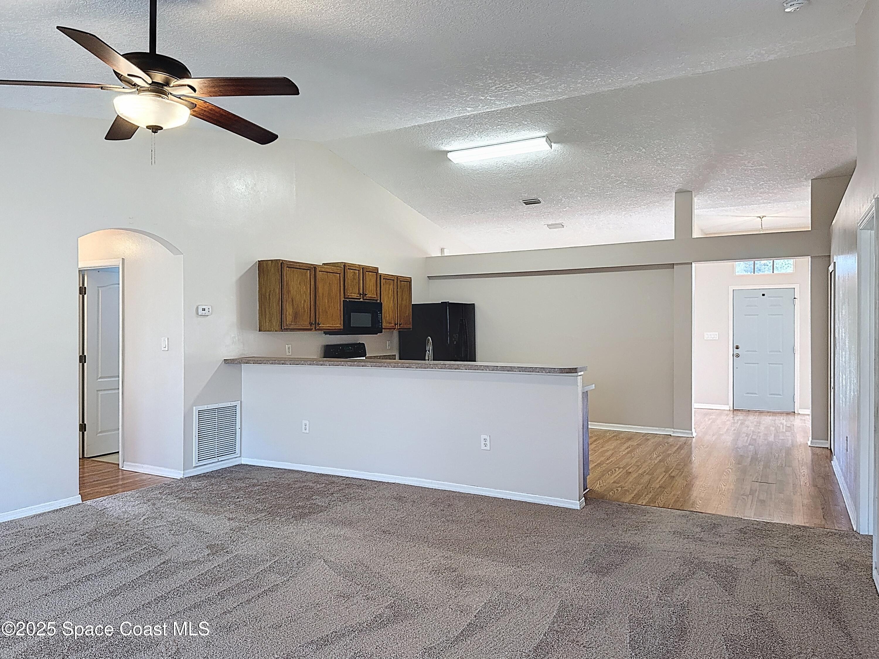 7370 Joshua Place Cocoa, FL 32927 - Photo 6 of 21 a view of a kitchen with a dishwasher and a refrigerator