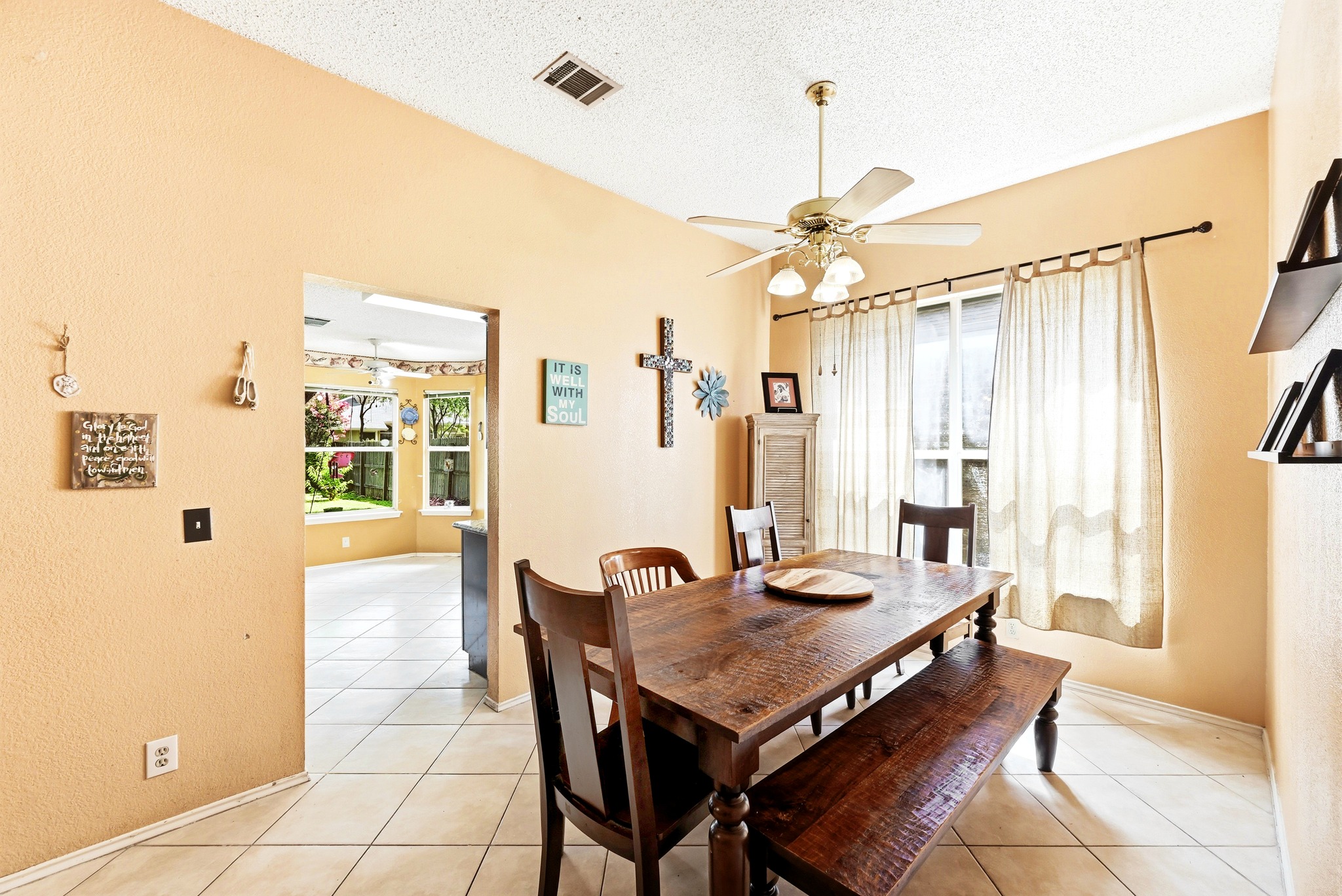 6412 Colton-Bluff Springs Road Austin, TX 78744 - Photo 8 of 27 A comfortable dining space features vaulted ceilings and tiled flooring, ideal for everyday meals.