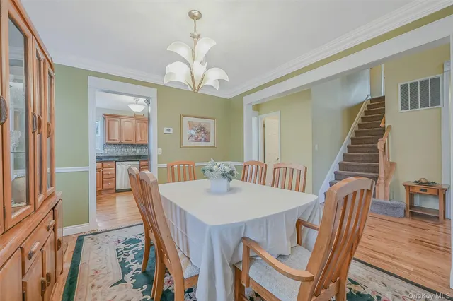 a view of a dining room with furniture wooden floor and chandelier