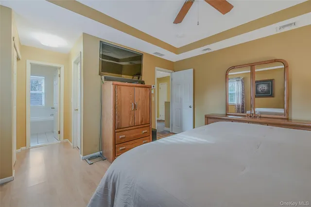 a bedroom with a bed and a large mirror