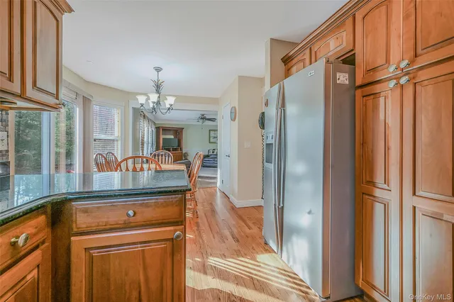 a kitchen with stainless steel appliances granite countertop a refrigerator and a sink