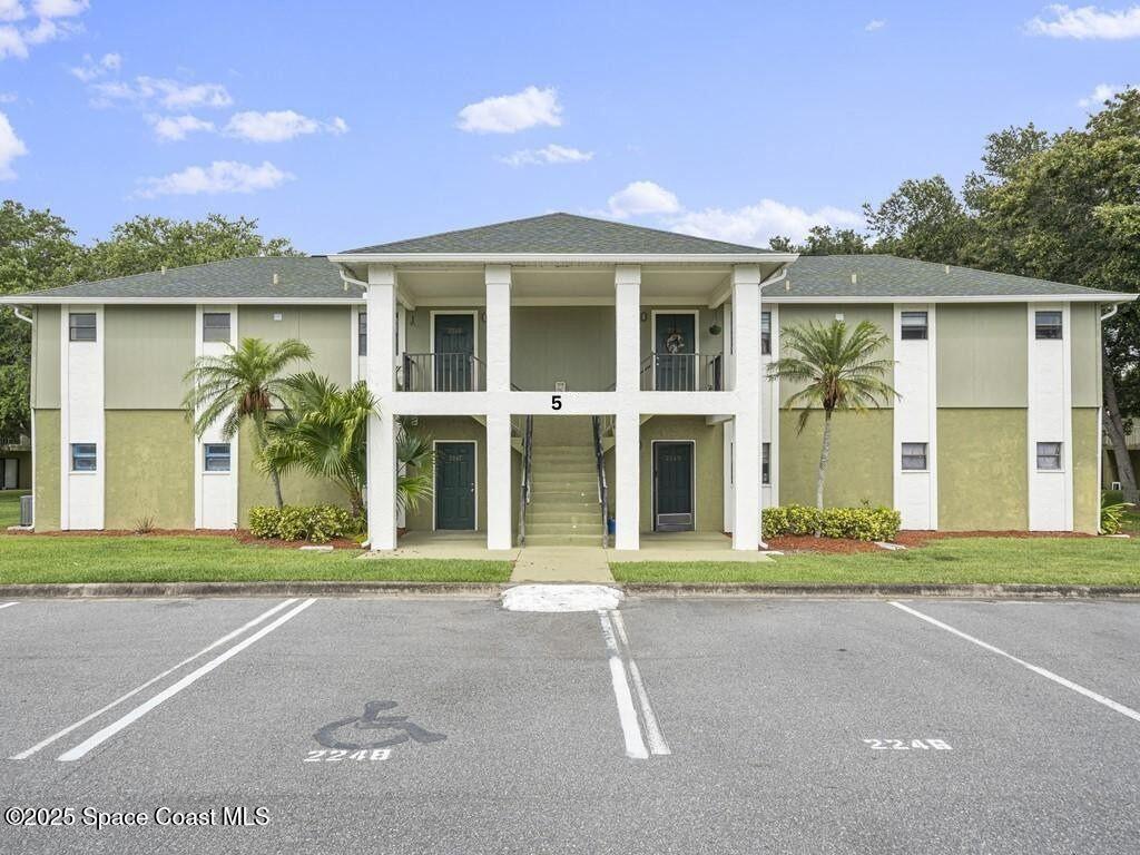 2220 Flower Tree Circle Melbourne, FL 32935 - Photo 1 of 22 a front view of a house with a garden