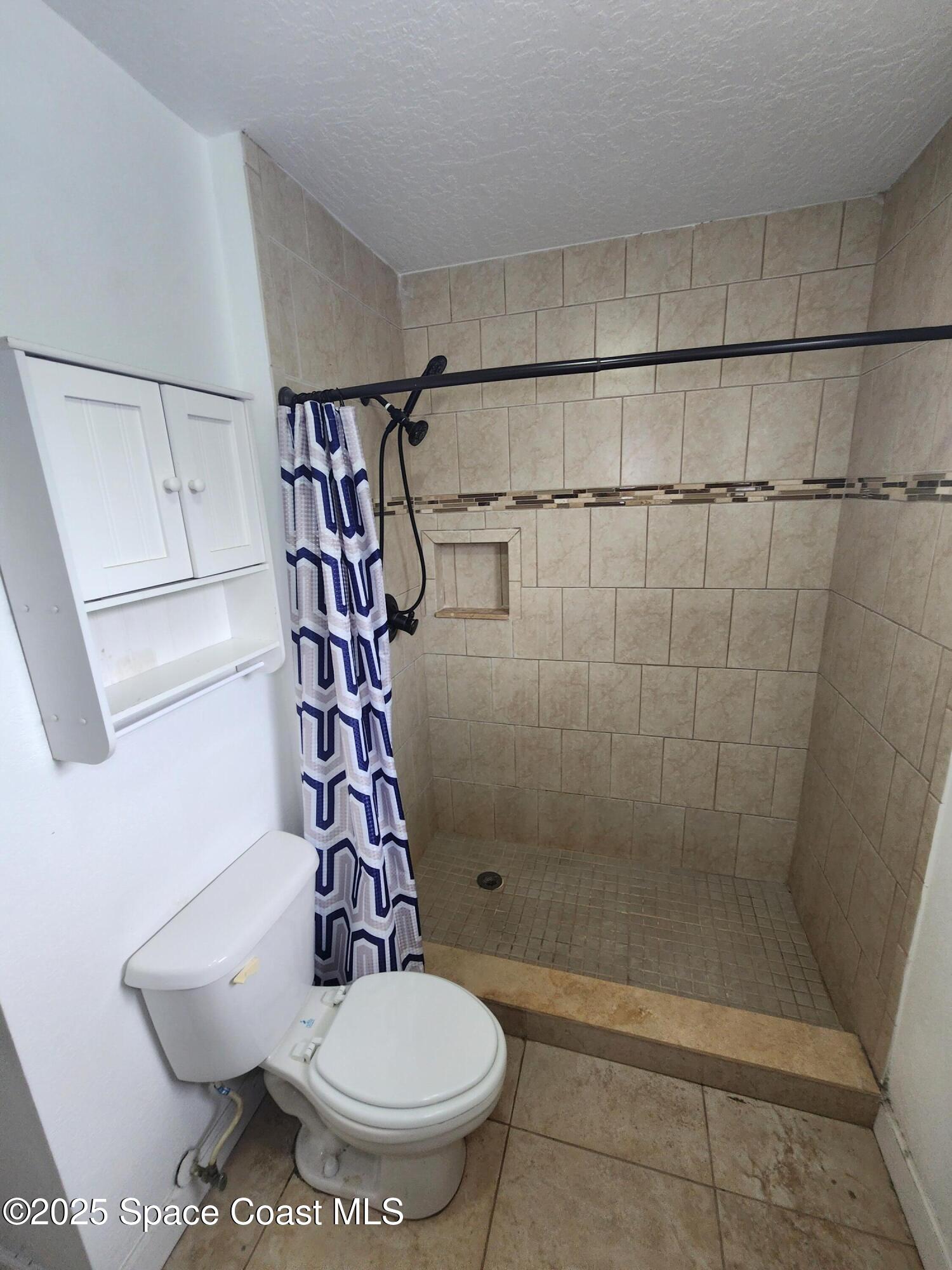2220 Flower Tree Circle Melbourne, FL 32935 - Photo 12 of 22 a bathroom with a shower and a toilet