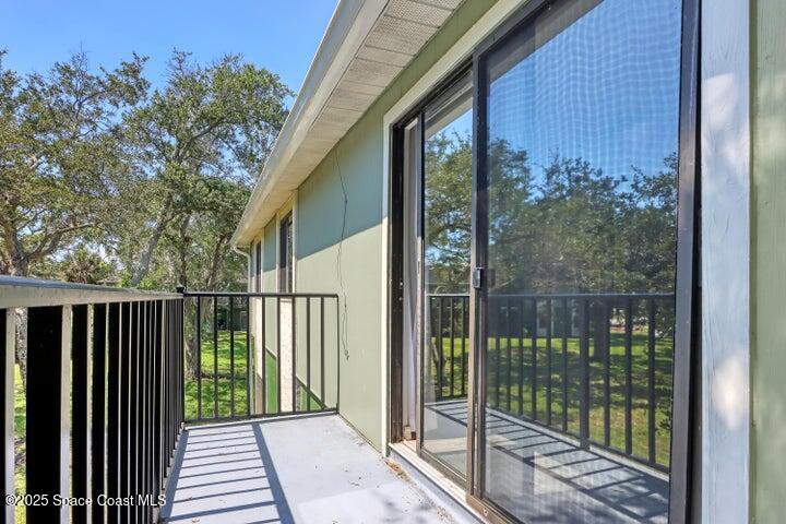 2220 Flower Tree Circle Melbourne, FL 32935 - Photo 15 of 22 a balcony with a garden view