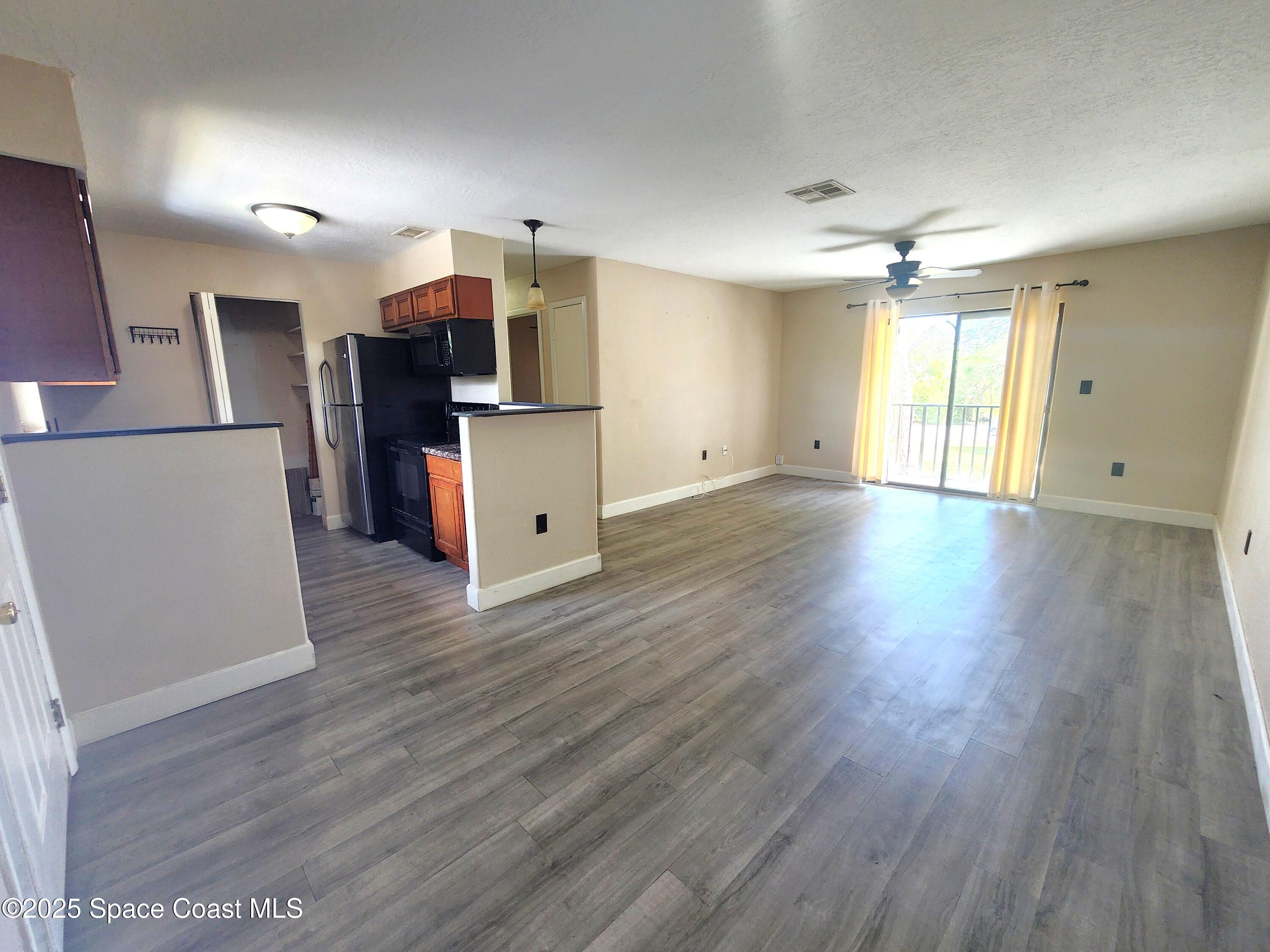 2220 Flower Tree Circle Melbourne, FL 32935 - Photo 2 of 22 a view of a kitchen with wooden floor