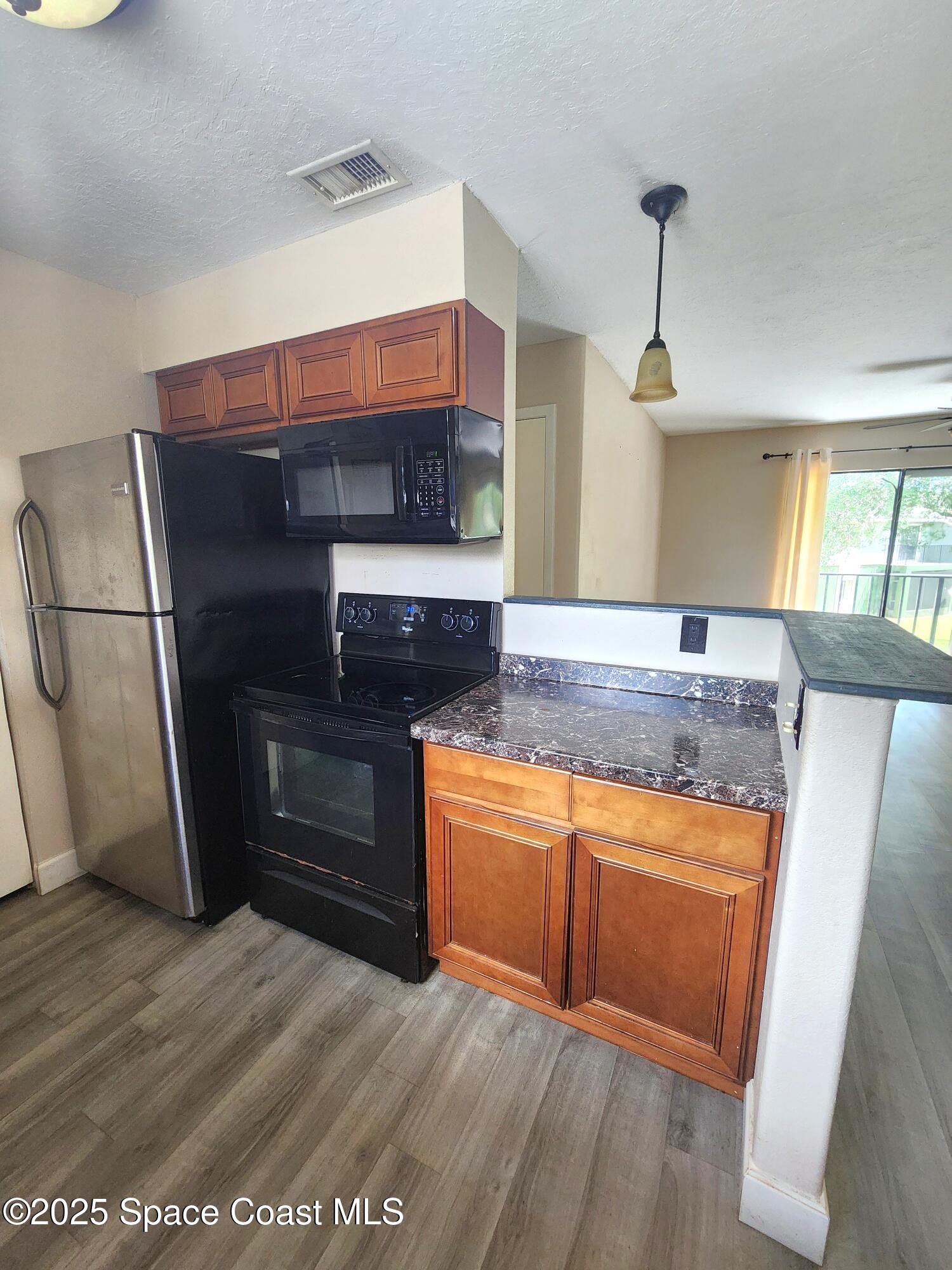 2220 Flower Tree Circle Melbourne, FL 32935 - Photo 6 of 22 a kitchen with stainless steel appliances granite countertop a refrigerator and a sink