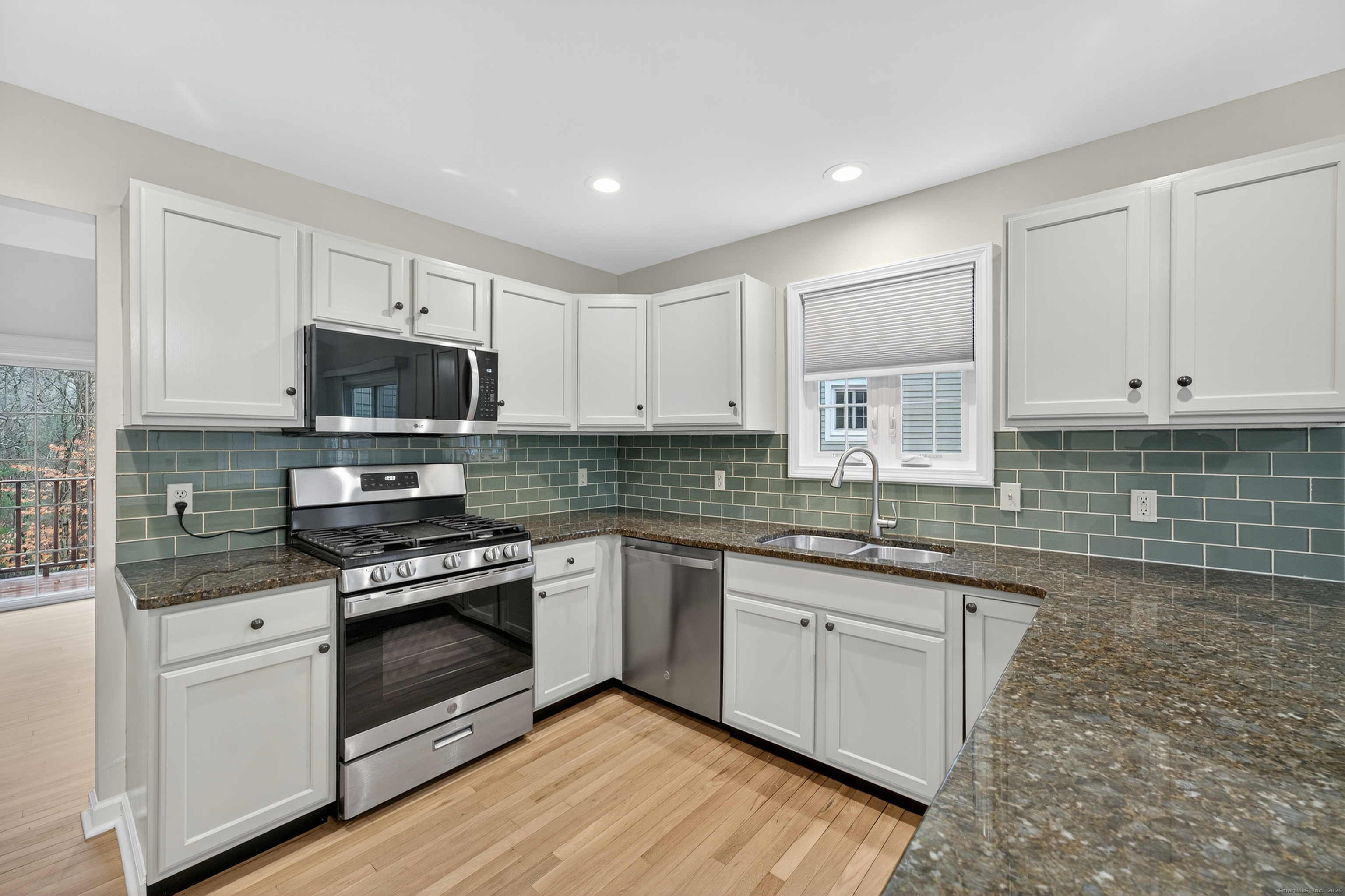 43 Copley Road, Unit 43 Glastonbury, CT 06073 - Photo 8 of 37 a kitchen with granite countertop white cabinets and white appliances
