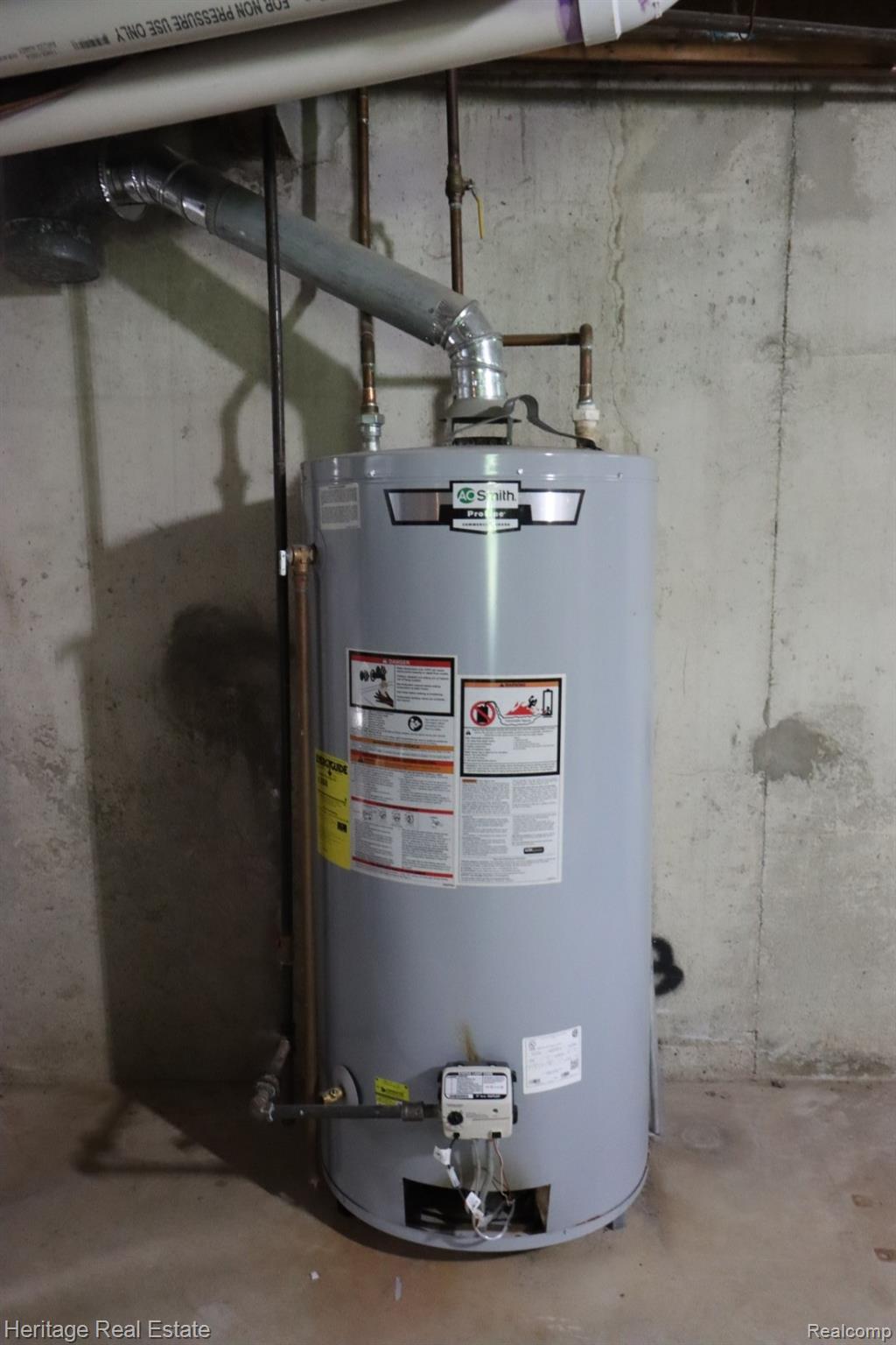 445 Mack Road Leonard, MI 48367 - Photo 37 of 41 Water heater with associated plumbing and ventilation