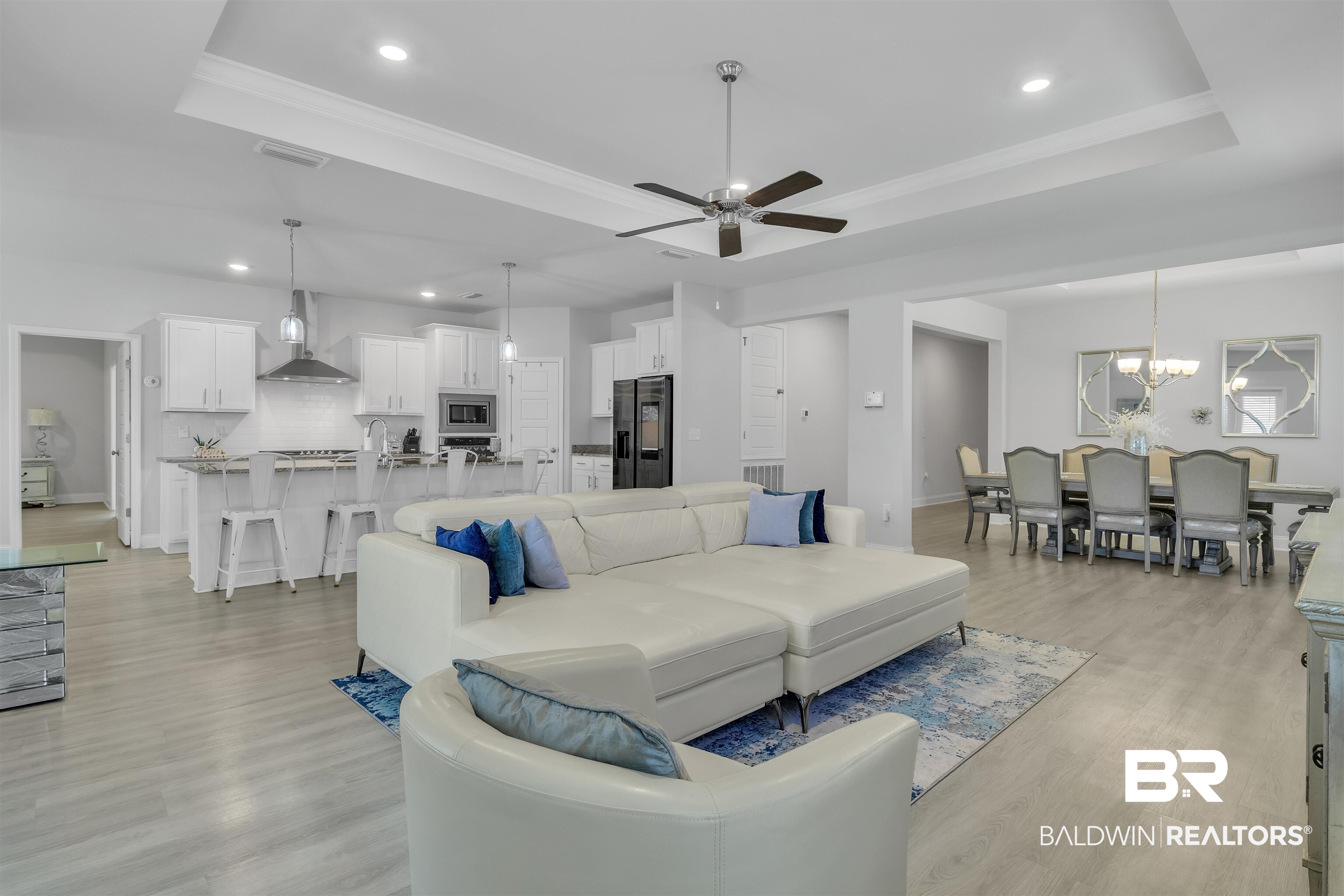 27862 Jade Court Daphne, AL 36526 - Photo 10 of 33 Living room featuring recessed lighting, a tray ceiling, visible vents, and ceiling fan with notable chandelier