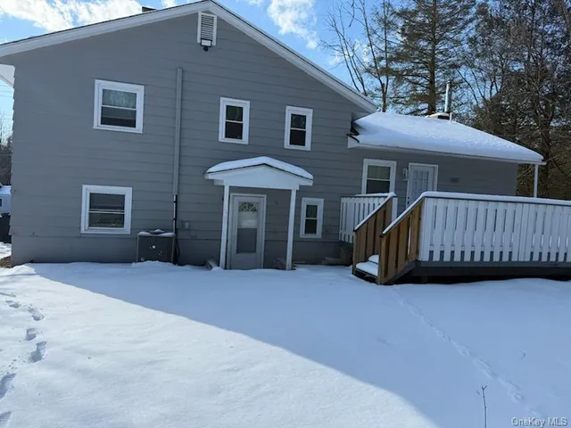 a view of a house with a yard and deck
