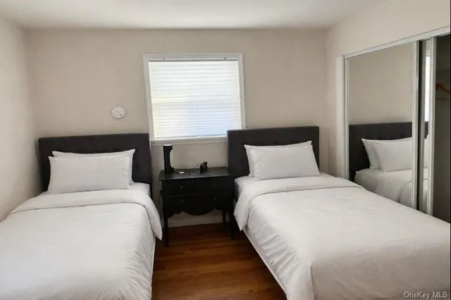 a large bed sitting in a bedroom next to a window