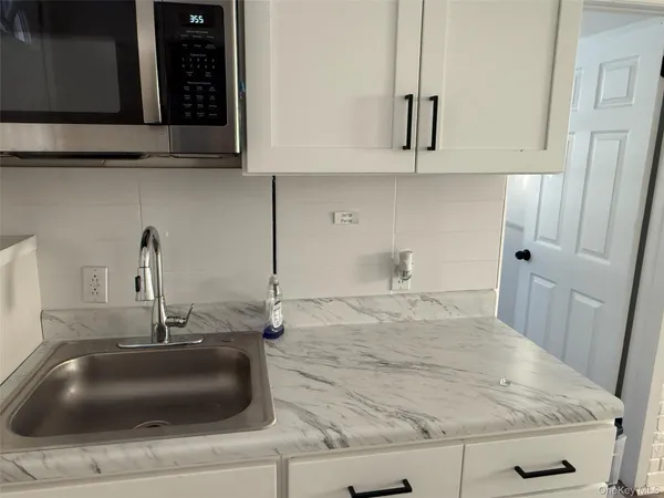 a bathroom with sink and mirror