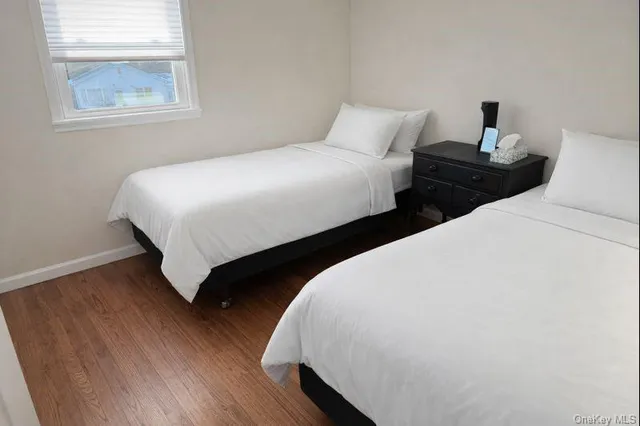 a bedroom with two beds and a window