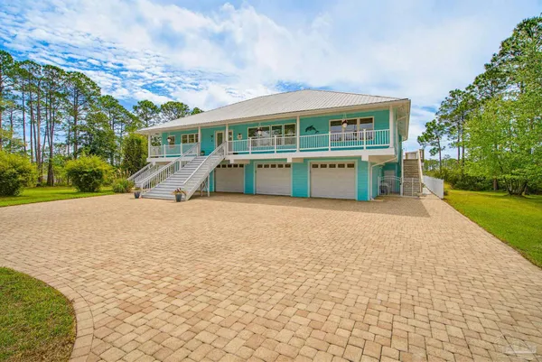 a front view of house with yard and lake view