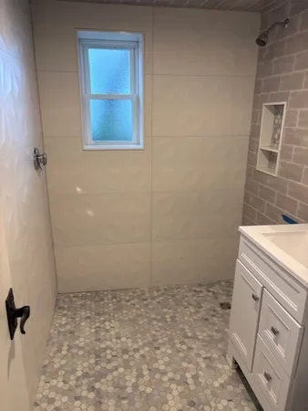 a bathroom with a sink toilet and shower