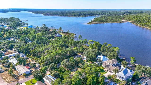 an aerial view of a house with a lake view