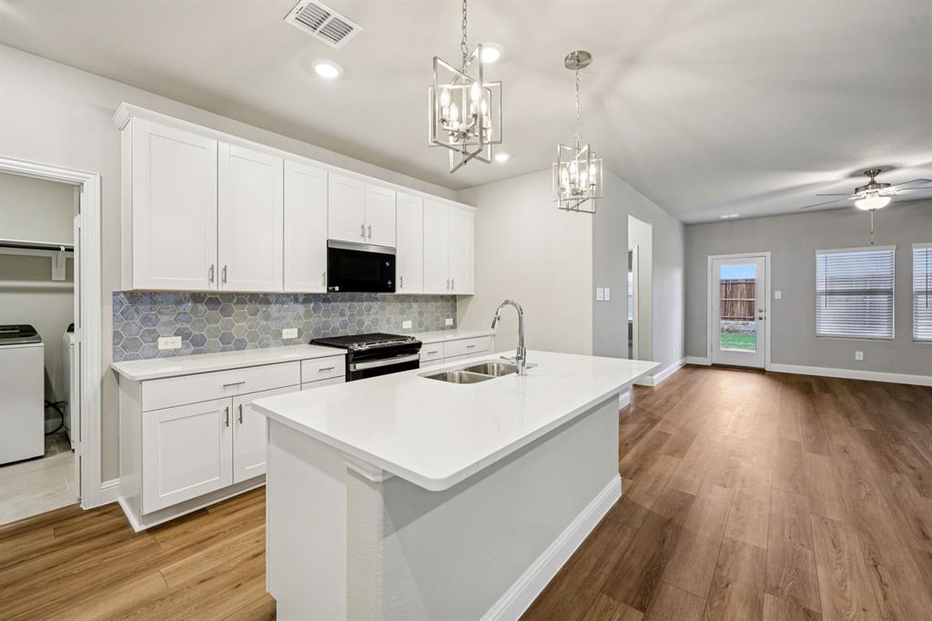 1721 Arches Road Anna, TX 75409 - Photo 13 of 39 a kitchen that has a lot of counter space and wooden floor