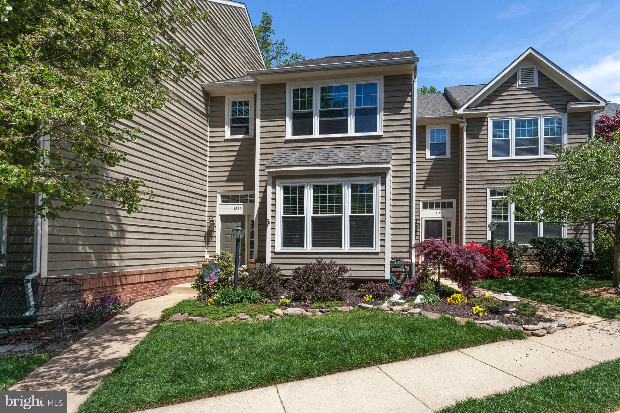1215 Weatherstone Court Reston, VA 20194 - Photo 1 of 30 a front view of a house with garden