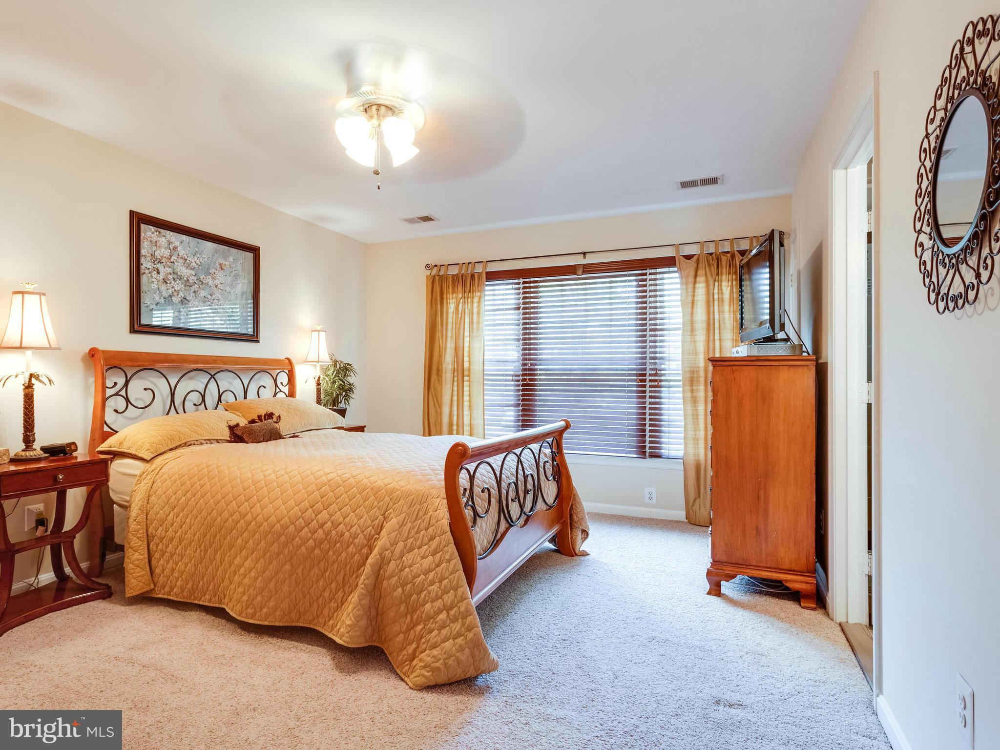 1215 Weatherstone Court Reston, VA 20194 - Photo 12 of 30 a bedroom with a bed and a chandelier