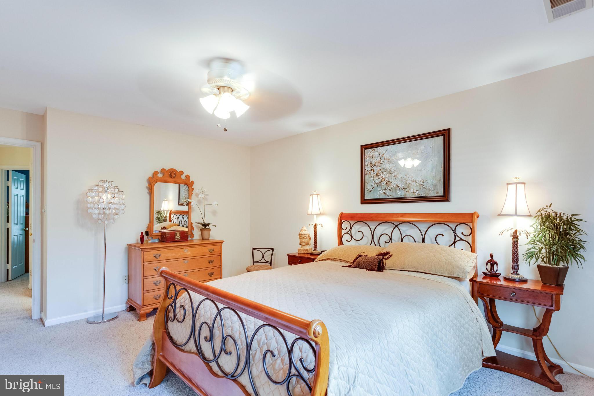 1215 Weatherstone Court Reston, VA 20194 - Photo 13 of 30 a bedroom with furniture and a chandelier
