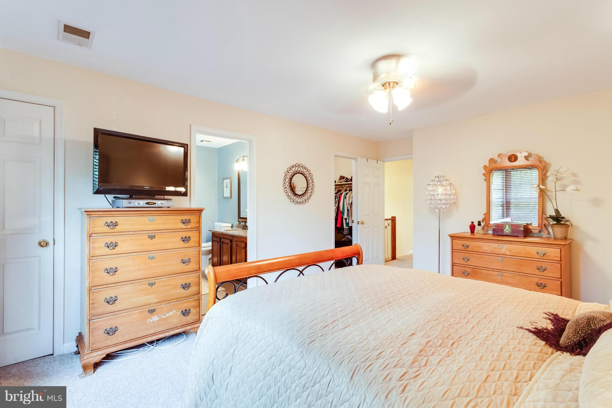1215 Weatherstone Court Reston, VA 20194 - Photo 14 of 30 a bedroom with a bed and a flat screen tv