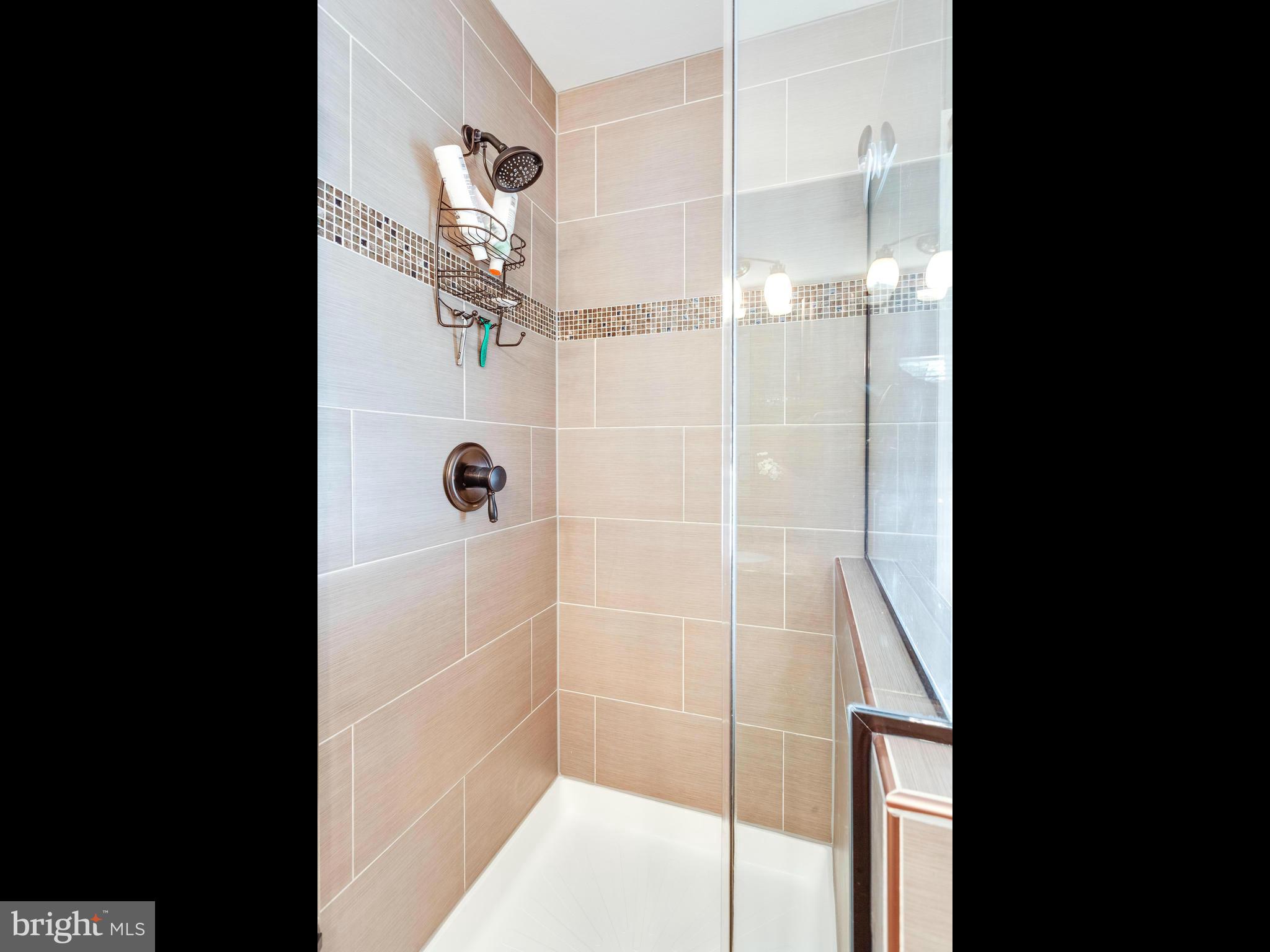 1215 Weatherstone Court Reston, VA 20194 - Photo 16 of 30 a bathroom with a glass shower door