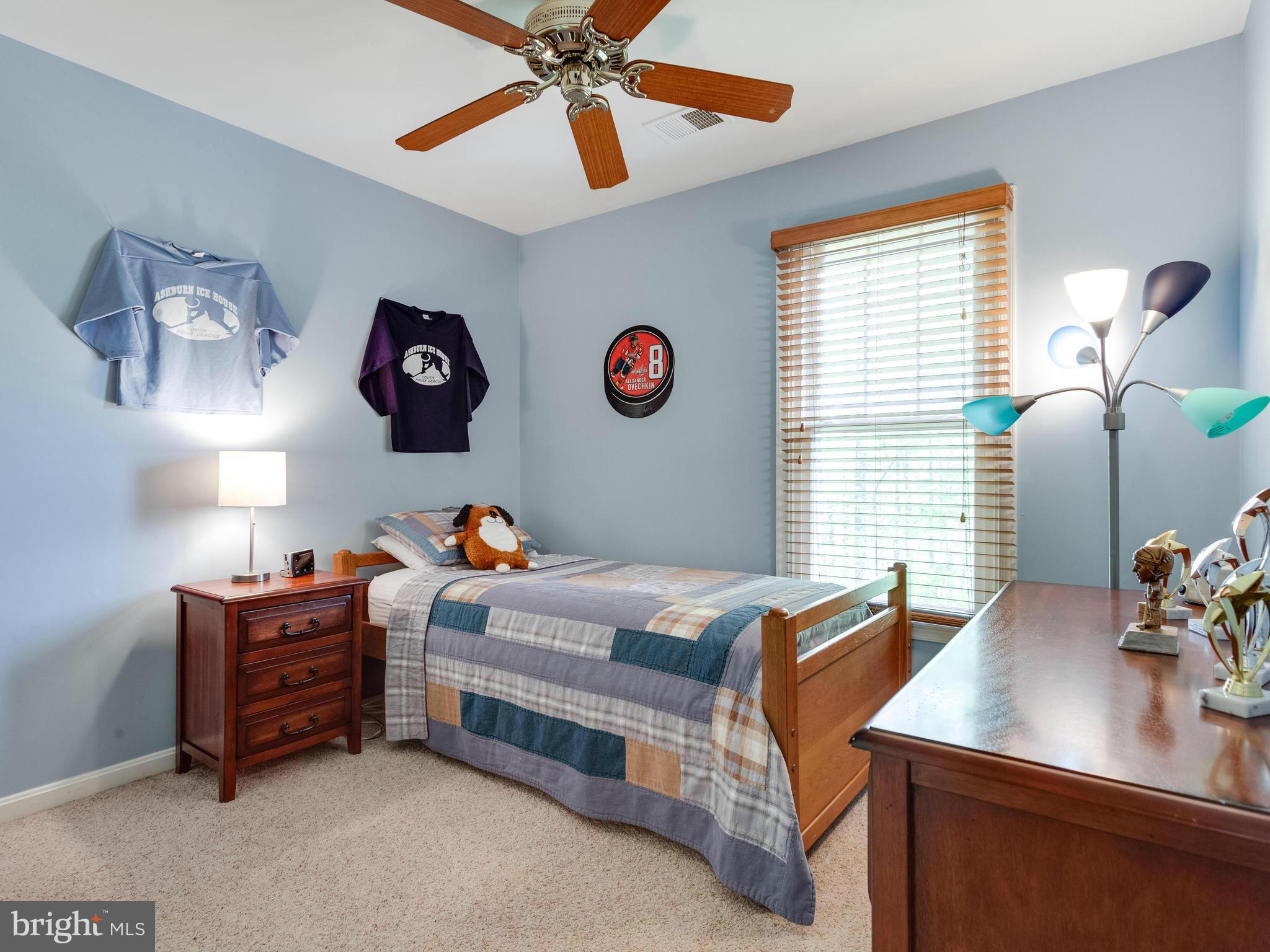 1215 Weatherstone Court Reston, VA 20194 - Photo 18 of 30 a bedroom with a bed and a chandelier