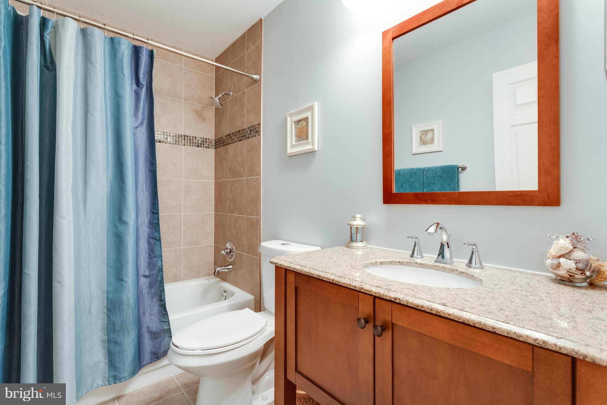 1215 Weatherstone Court Reston, VA 20194 - Photo 20 of 30 a bathroom with a granite countertop sink toilet and shower
