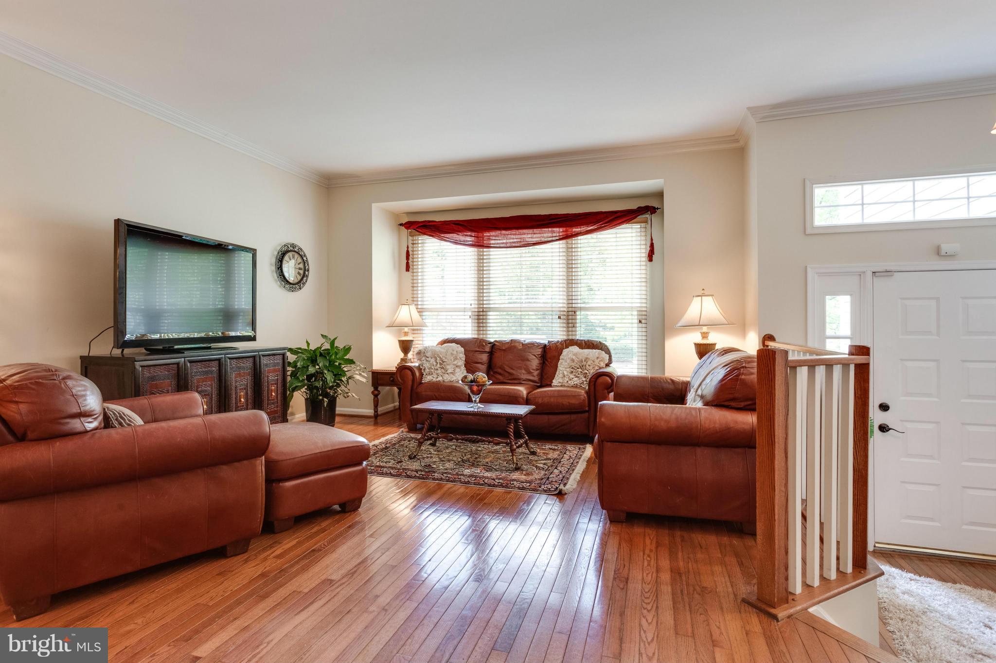 1215 Weatherstone Court Reston, VA 20194 - Photo 3 of 30 a living room with furniture and a flat screen tv