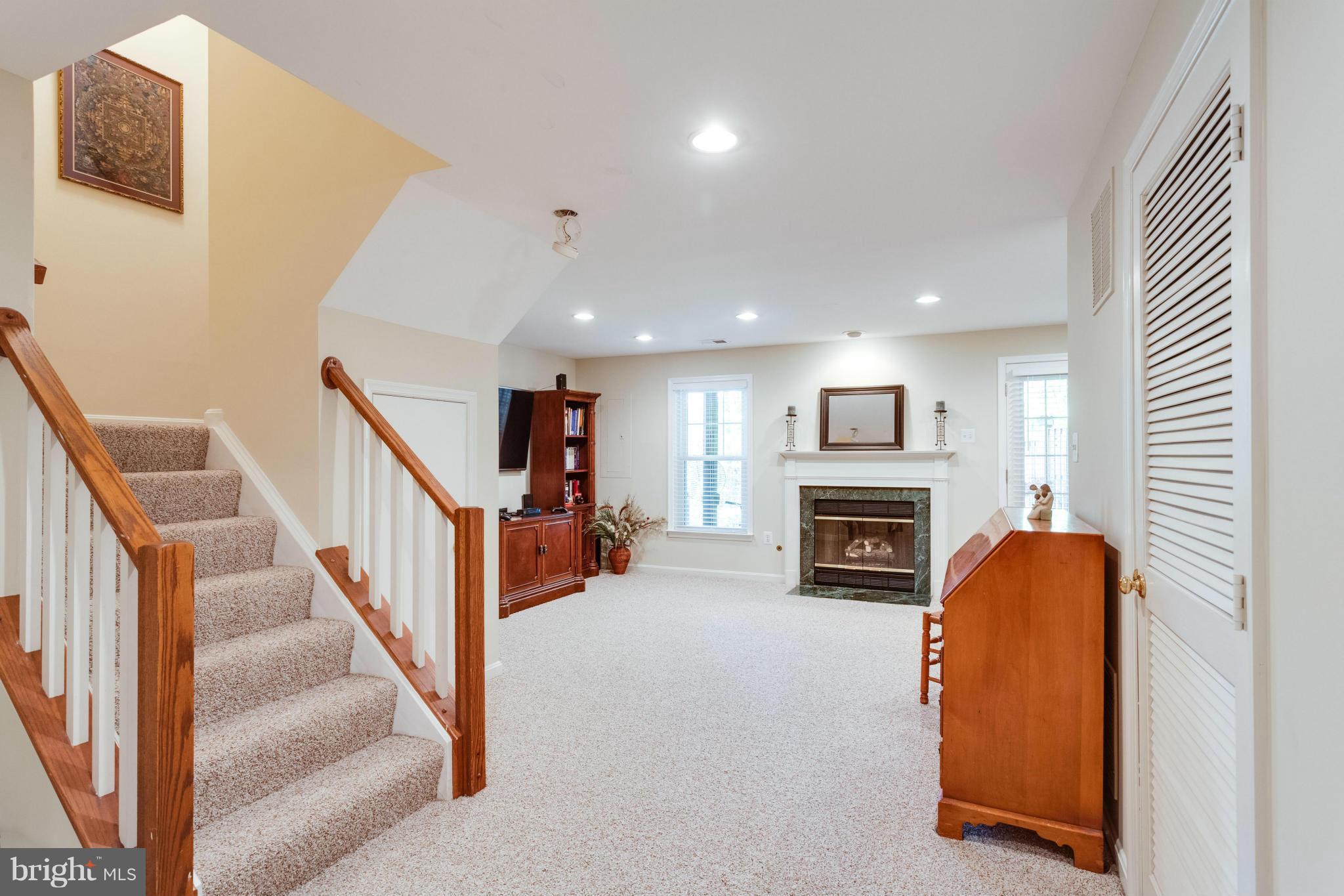 1215 Weatherstone Court Reston, VA 20194 - Photo 21 of 30 a view of a livingroom with a fireplace a ceiling fan a fireplace and entryway
