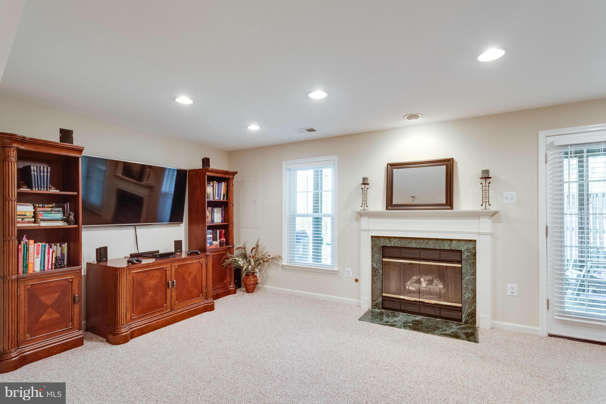 1215 Weatherstone Court Reston, VA 20194 - Photo 22 of 30 a living room with furniture and a fireplace