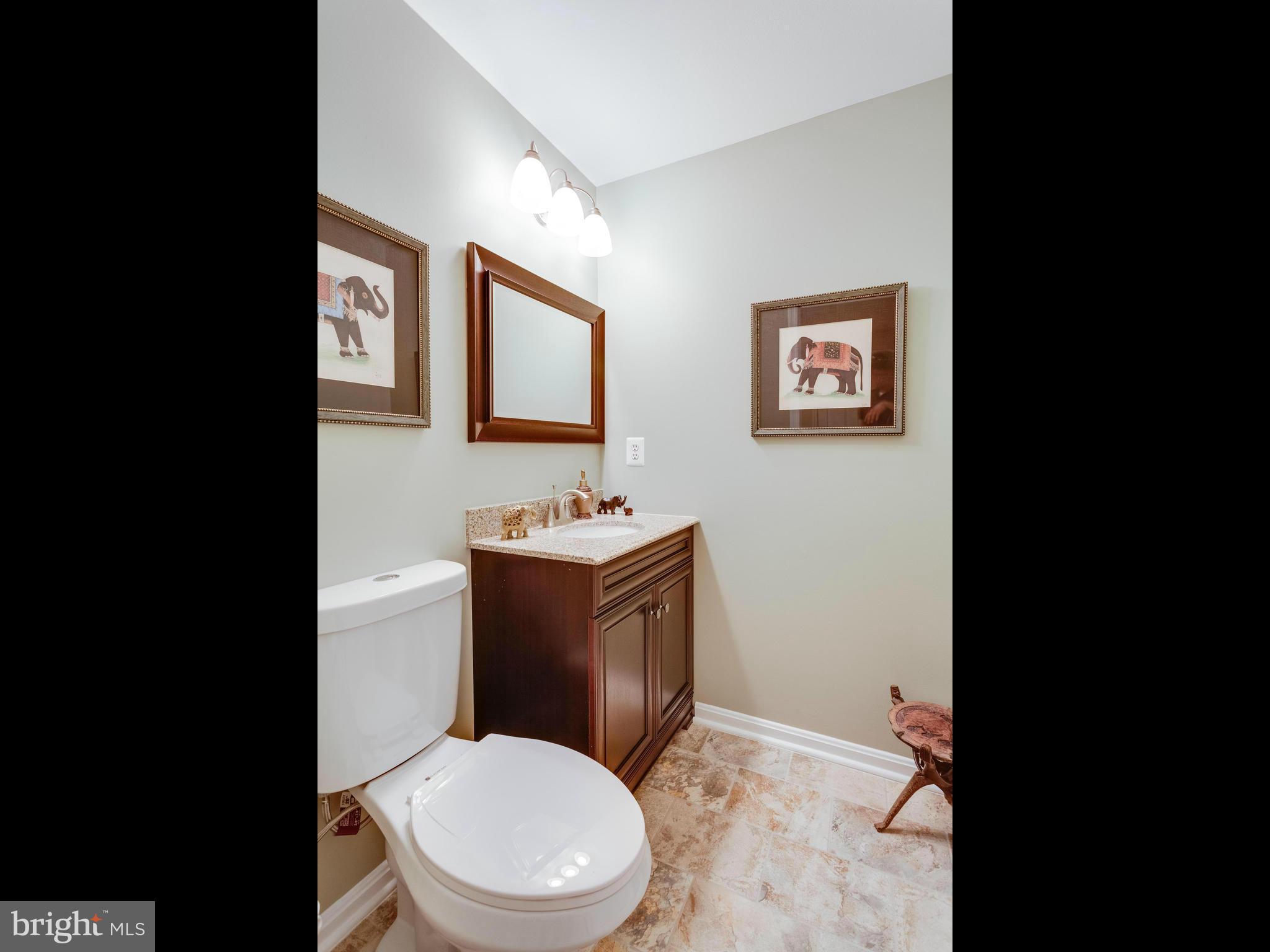 1215 Weatherstone Court Reston, VA 20194 - Photo 26 of 30 a bathroom with a toilet sink vanity and mirror