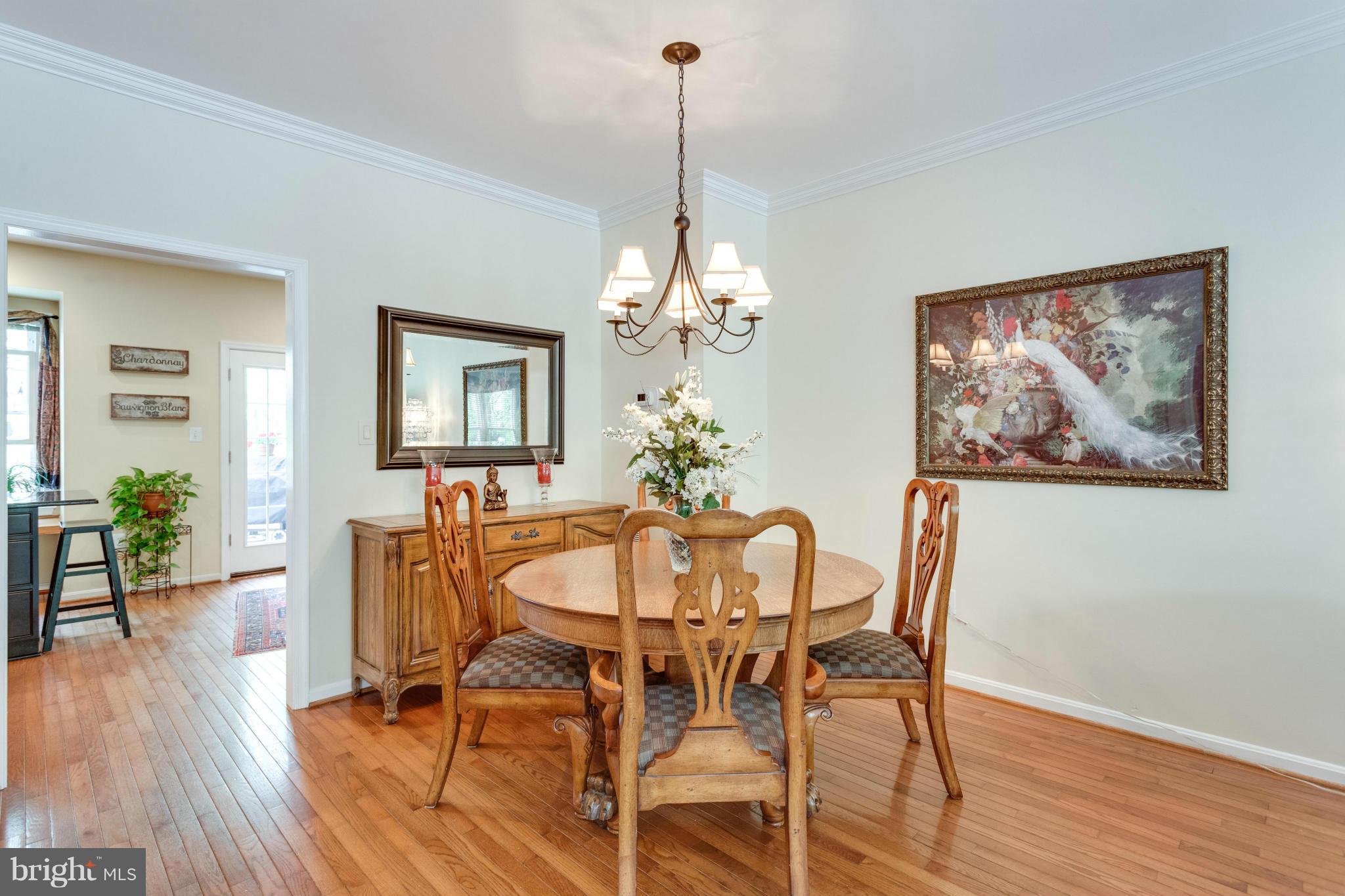 1215 Weatherstone Court Reston, VA 20194 - Photo 6 of 30 a dining room with furniture potted plants and wooden floor