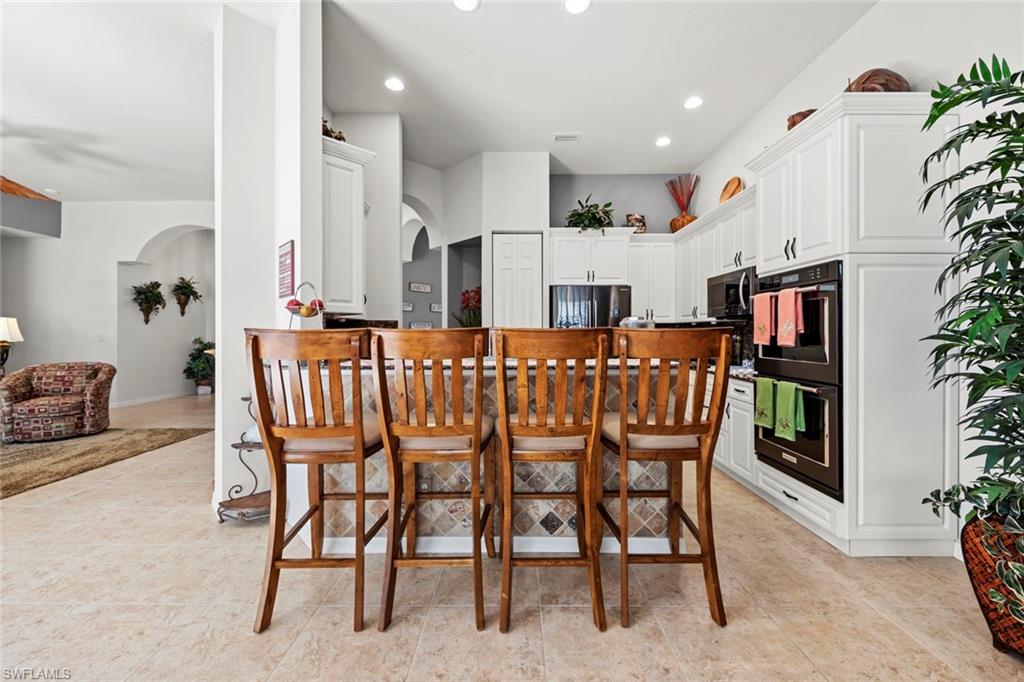 9006 Whitfield Drive Estero, FL 33928 - Photo 11 of 43 a dining room with furniture and wooden floor
