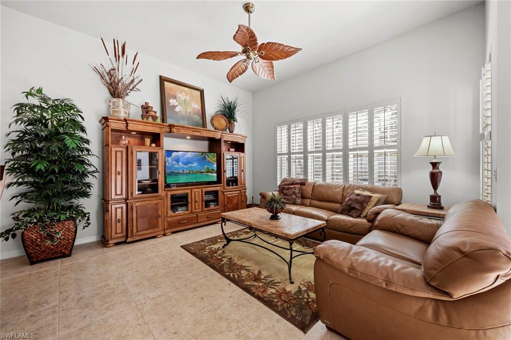 9006 Whitfield Drive Estero, FL 33928 - Photo 12 of 43 a living room with furniture a window and a flat screen tv