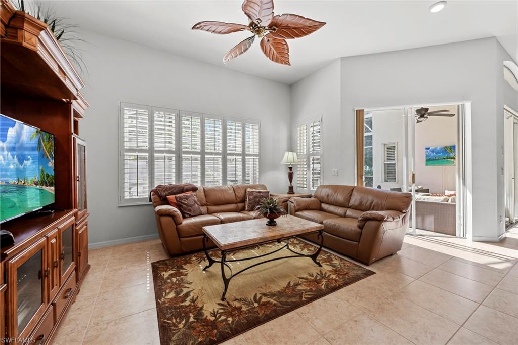 9006 Whitfield Drive Estero, FL 33928 - Photo 13 of 43 a living room with furniture a flat screen tv and a window