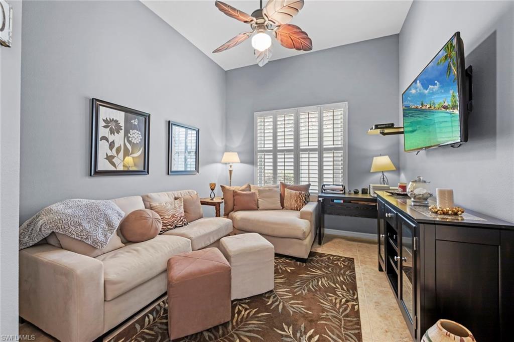 9006 Whitfield Drive Estero, FL 33928 - Photo 14 of 43 a living room with furniture a flat screen tv and a window