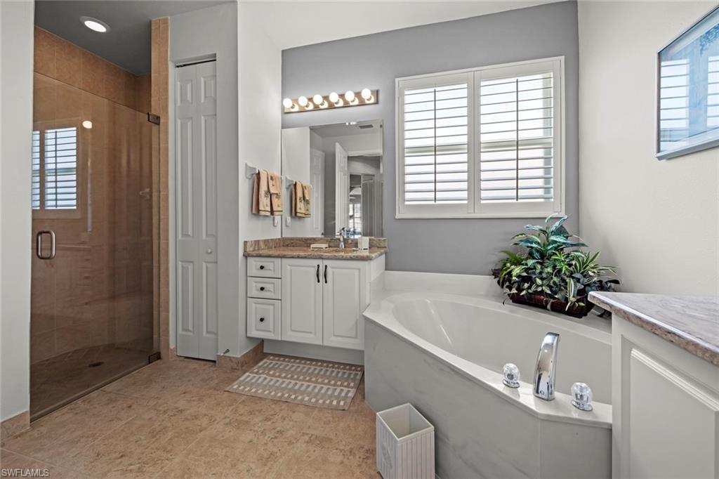 9006 Whitfield Drive Estero, FL 33928 - Photo 18 of 43 a spacious bathroom with a sink a large mirror and a shower