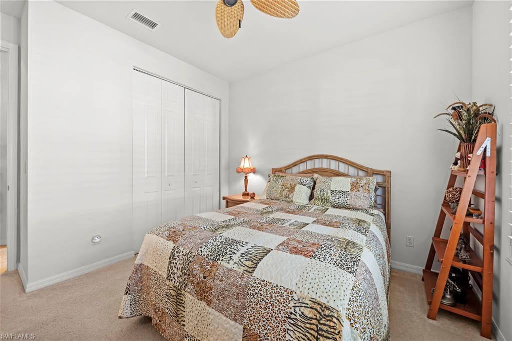 9006 Whitfield Drive Estero, FL 33928 - Photo 20 of 43 a bedroom with a bed and a window