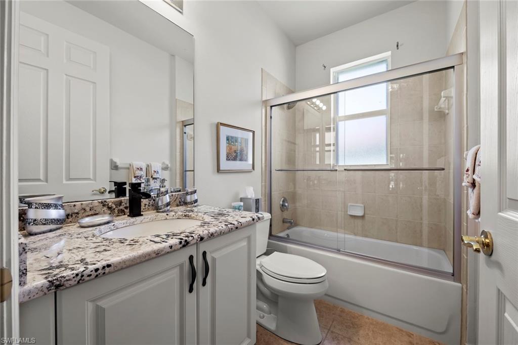 9006 Whitfield Drive Estero, FL 33928 - Photo 21 of 43 a bathroom with a granite countertop sink toilet and shower