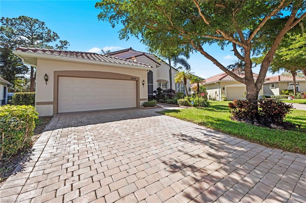 9006 Whitfield Drive Estero, FL 33928 - Photo 34 of 43 a front view of a house with a yard and a garage