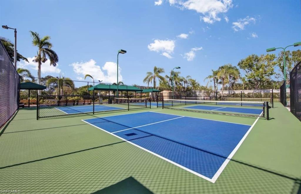 9006 Whitfield Drive Estero, FL 33928 - Photo 40 of 43 a view of a tennis ground with large trees