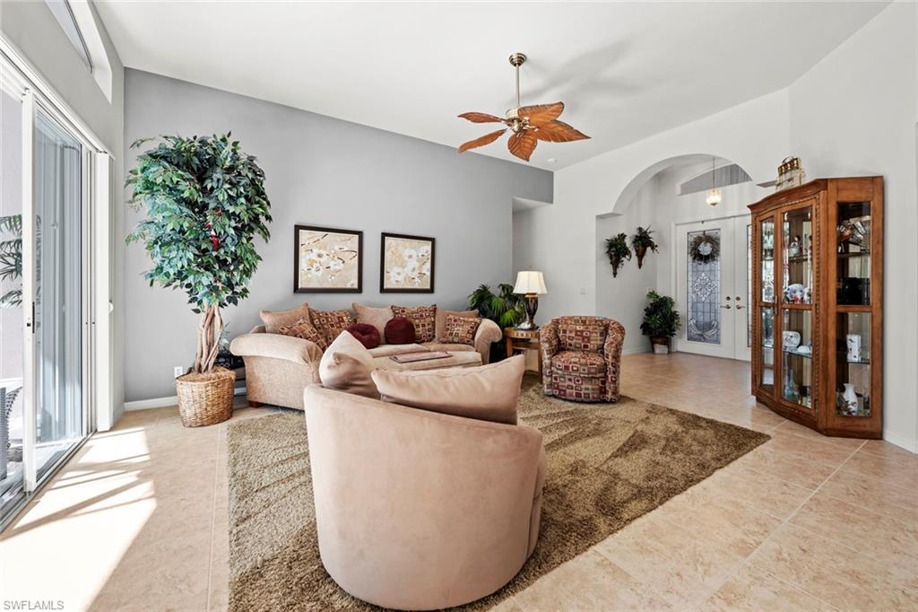 9006 Whitfield Drive Estero, FL 33928 - Photo 6 of 43 a living room with furniture and a chandelier